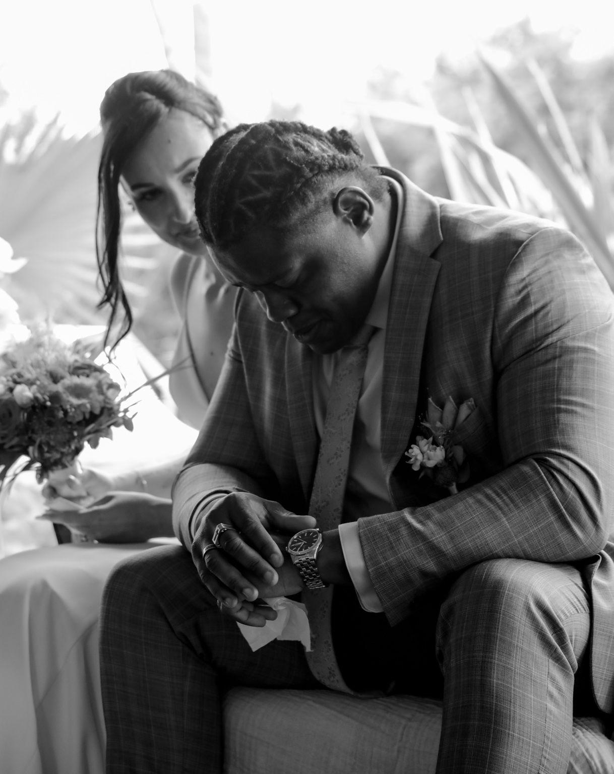 Anthony holding a handkerchief with Marina beside him, in black and white