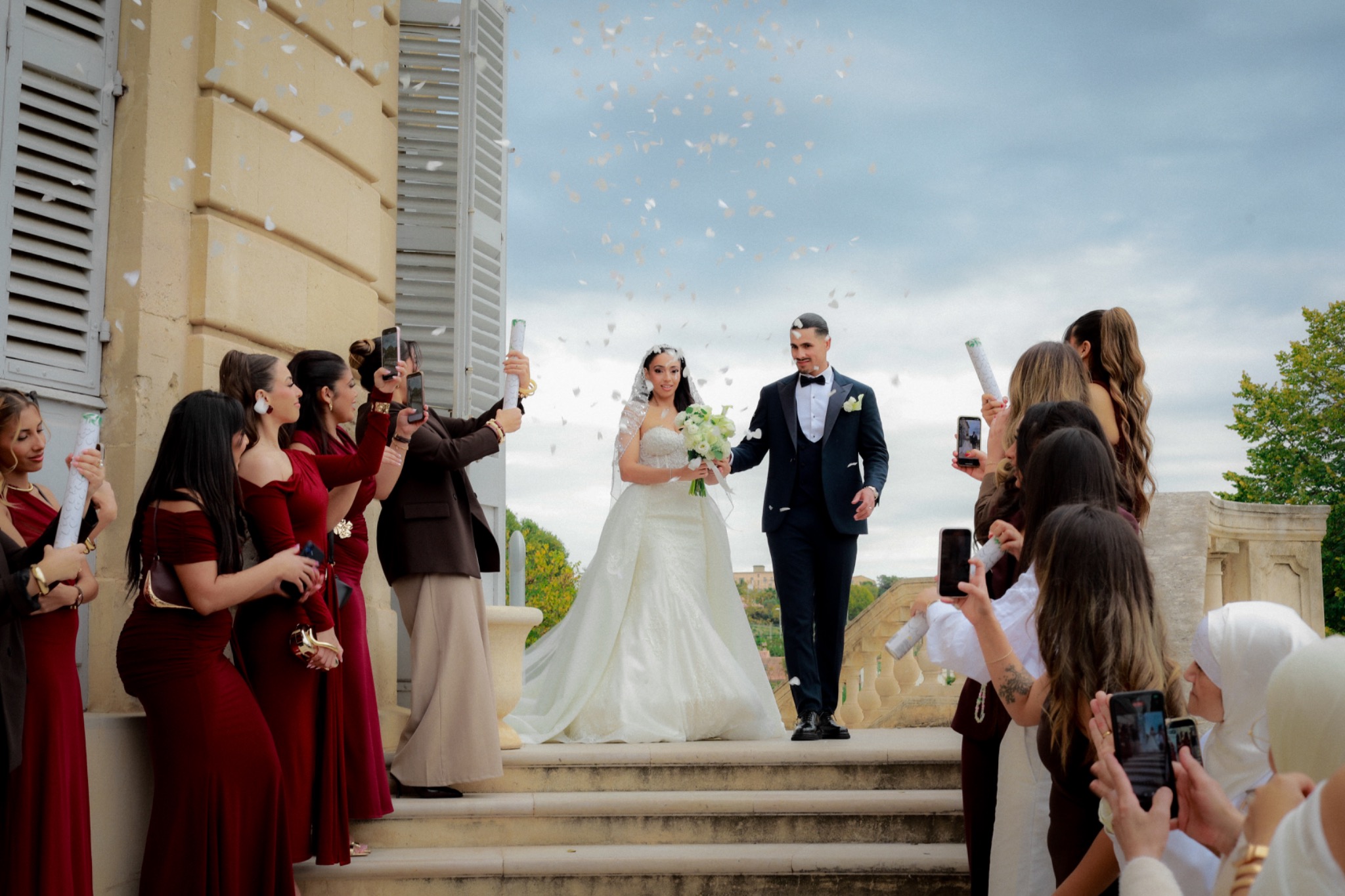 Newlyweds leaving the ceremony under a shower of confetti