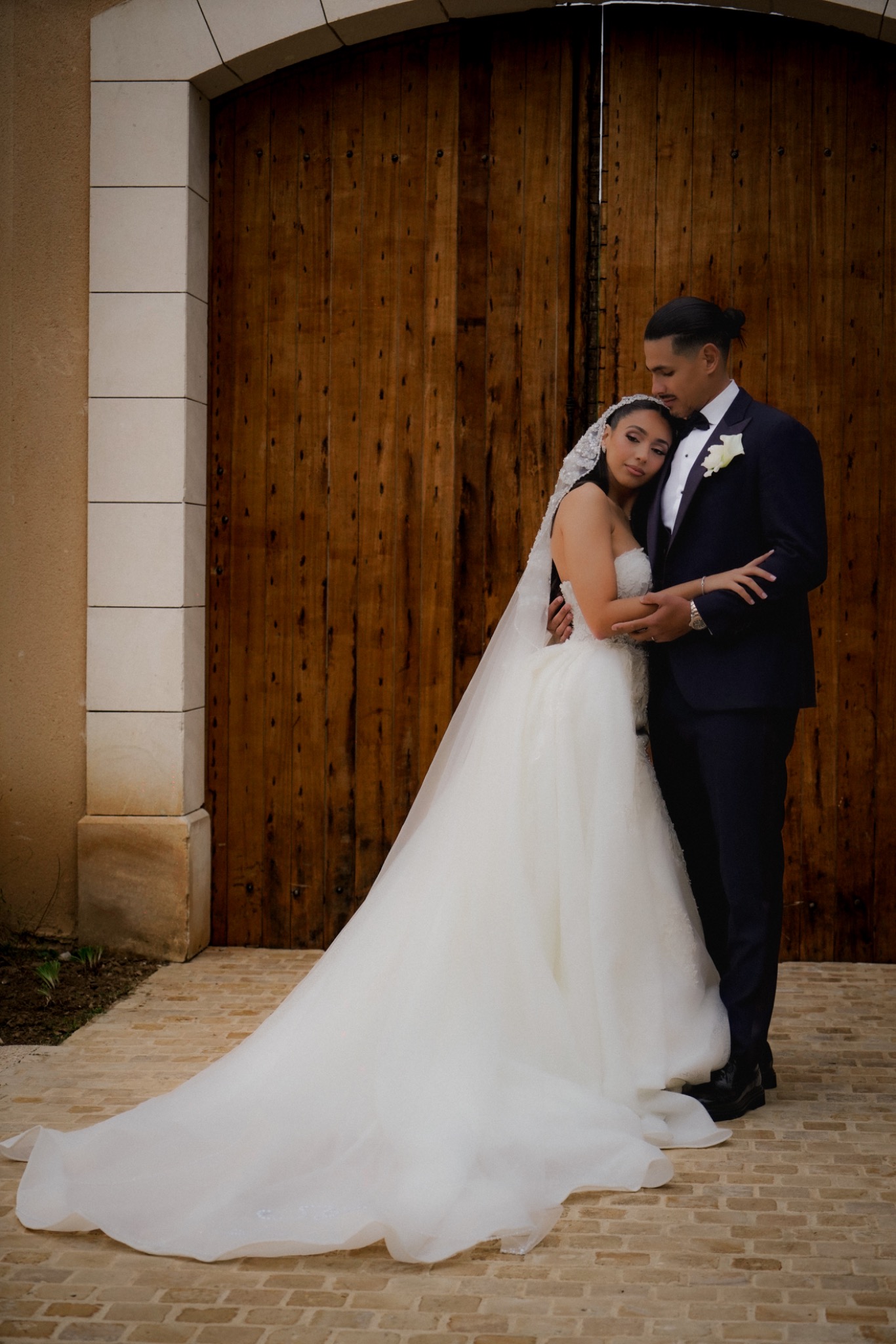 Portrait of newlyweds in front of an old doorway