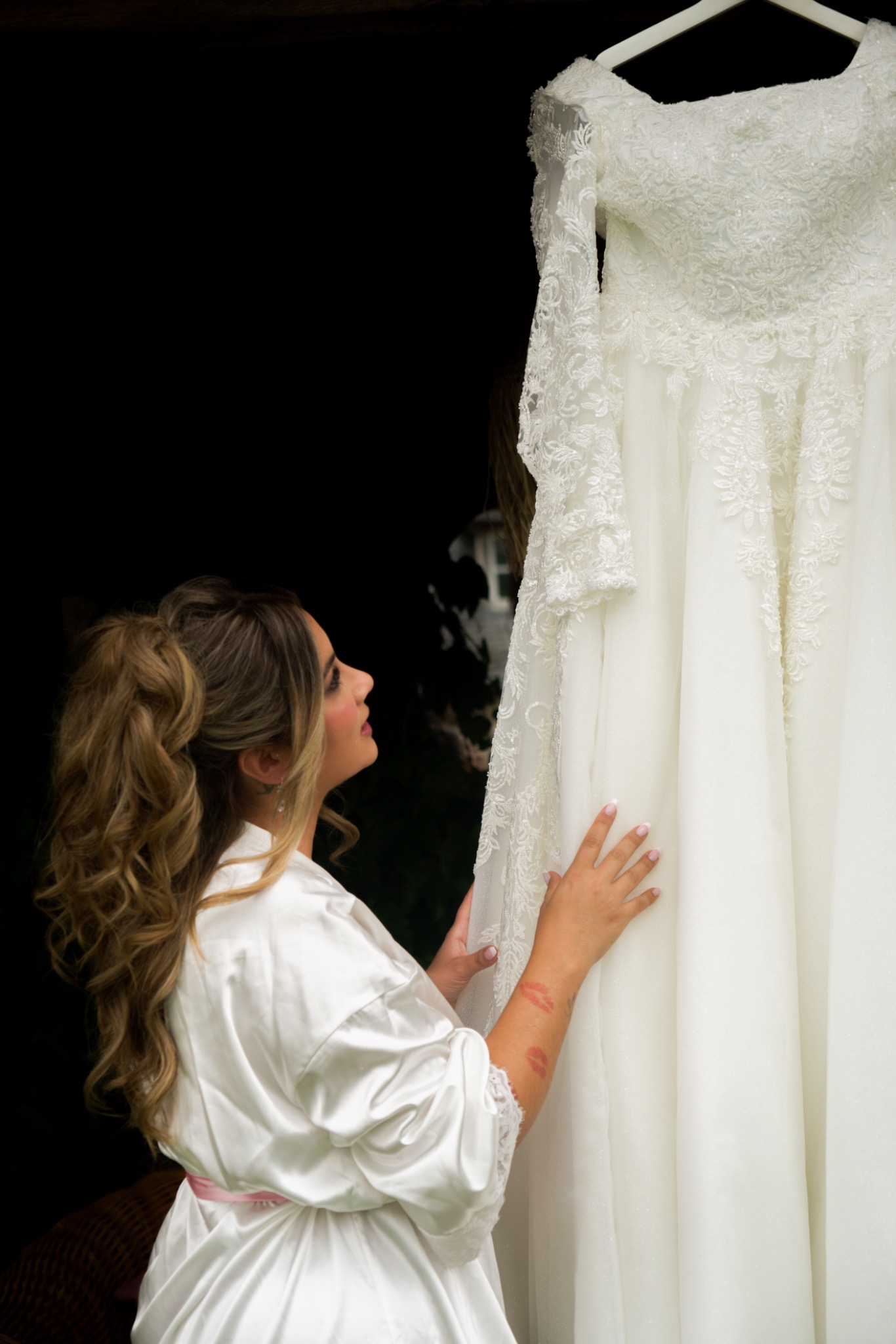 Bride looking at her dress while getting ready