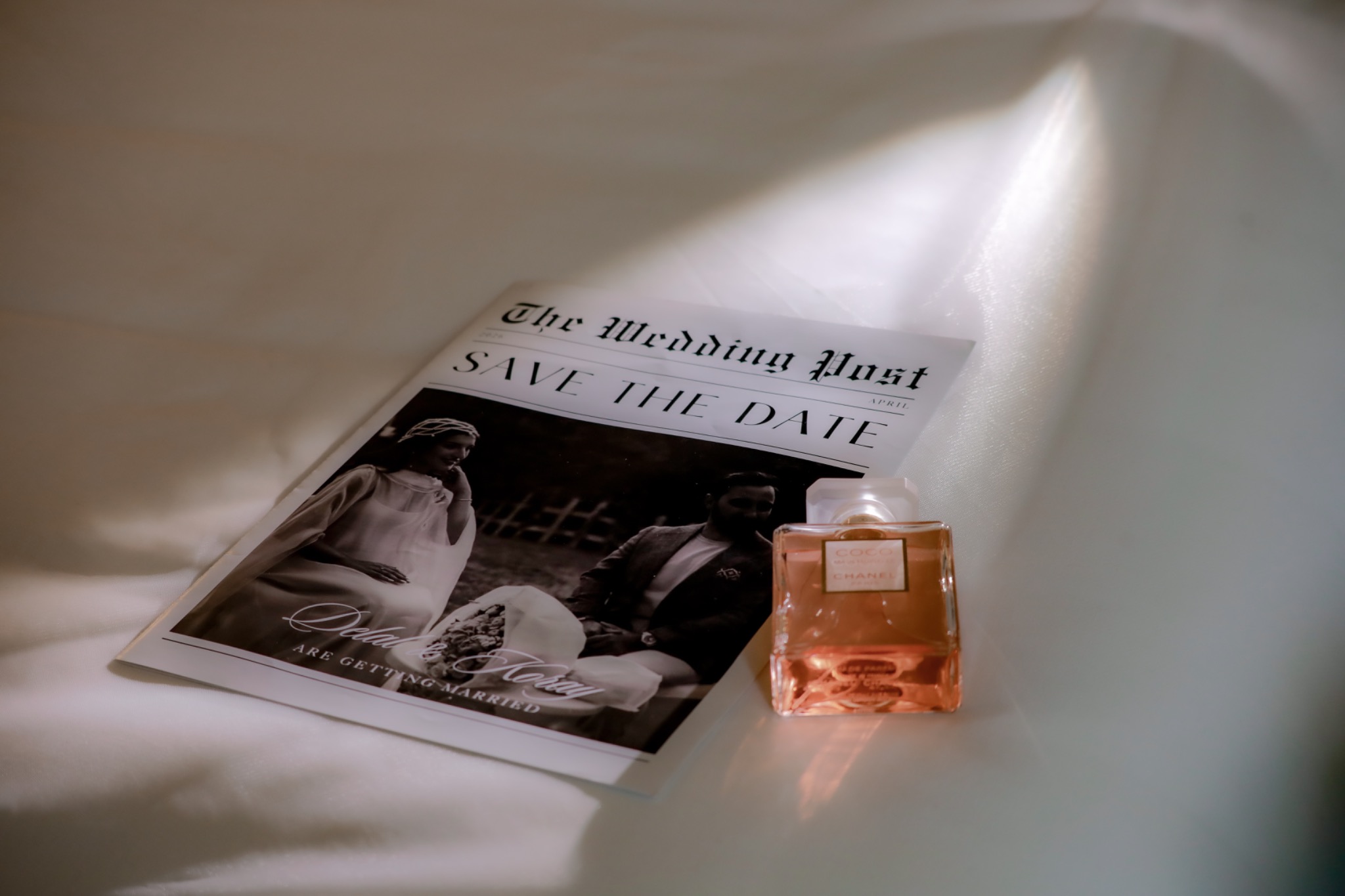 Wedding stationery and perfume in soft light