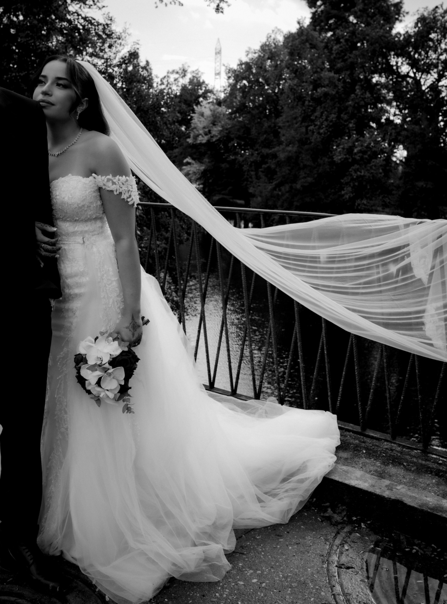 Bride on a bridge with her long veil in motion